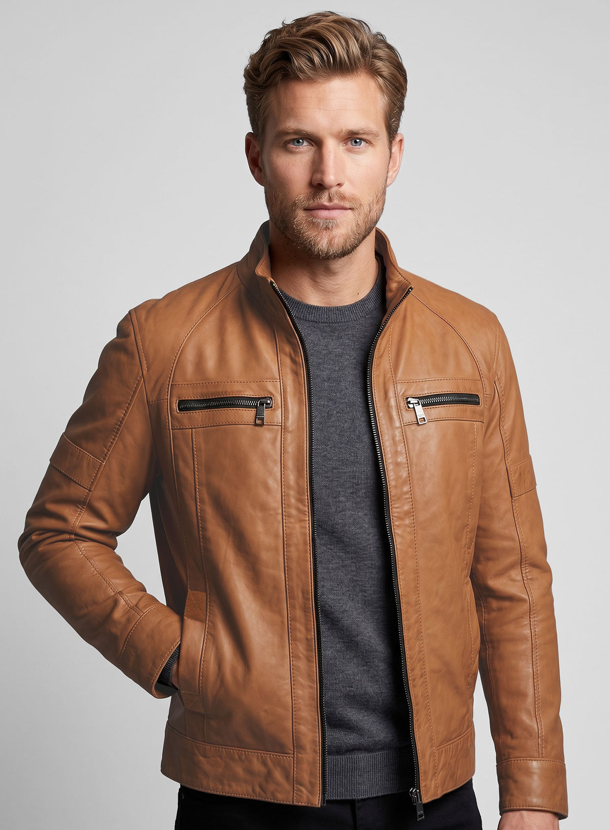 Man wearing an open tan leather jacket with stand collar and zip chest pockets