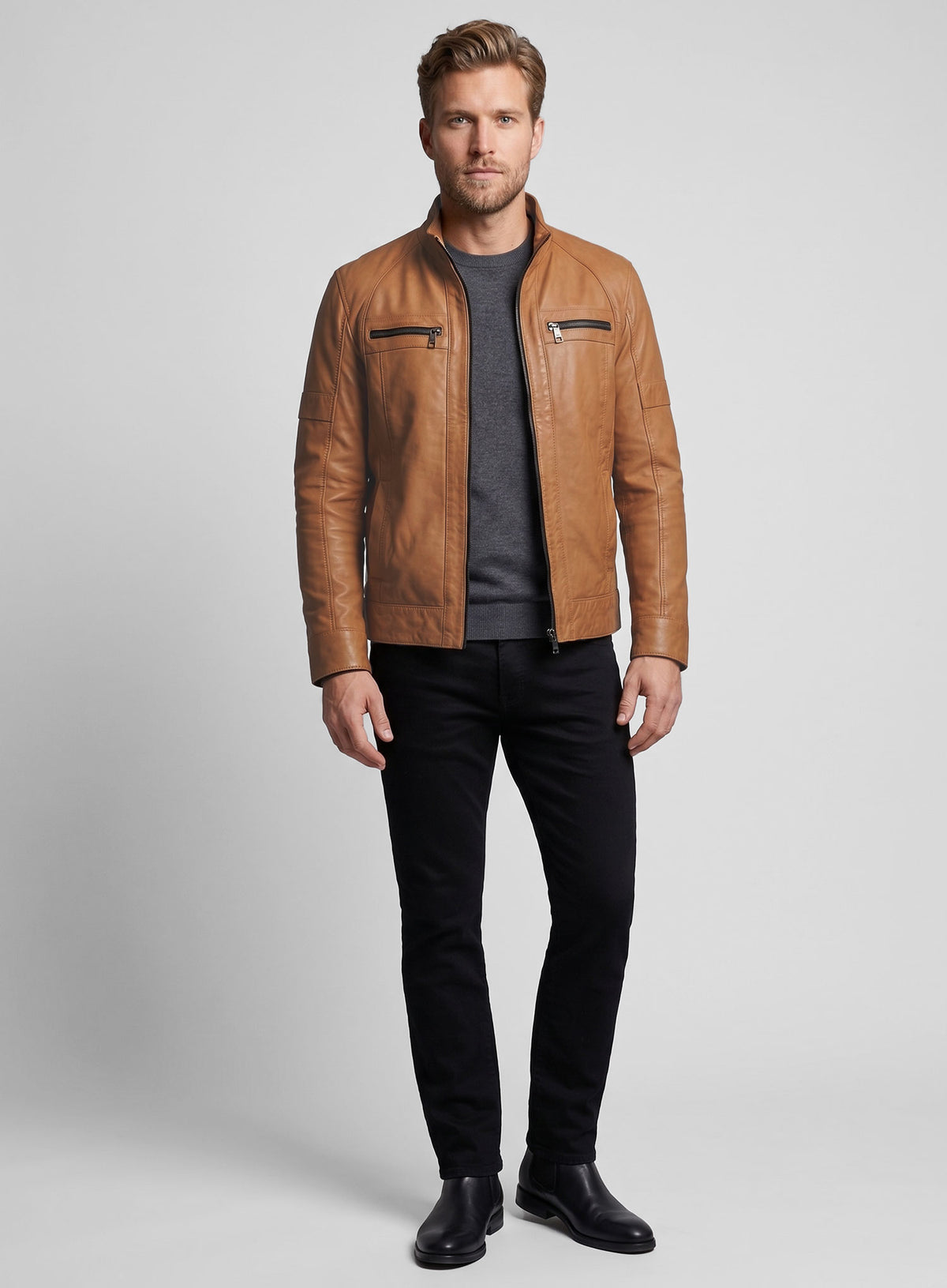 Full-length view of man in a tan leather jacket with chest zip pockets and black jeans