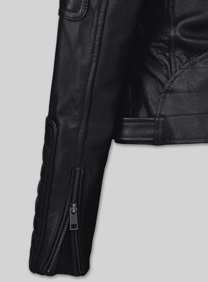 Close-up of a black leather biker jacket sleeve with a zip cuff and quilted panel