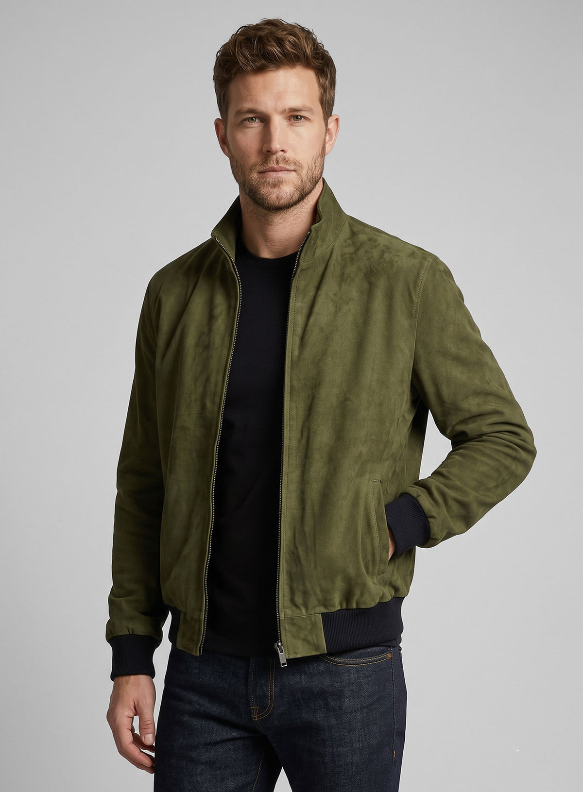 Man wearing a woodland green suede bomber jacket with ribbed cuffs, open zipper